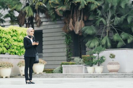 young executive businesswoman in black suit standing with confident face expression
