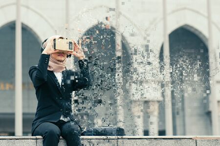 pixelated effect, hijab businesswoman experiencing in virtual reality glasses for controlling successful business solutions and developmentの写真素材