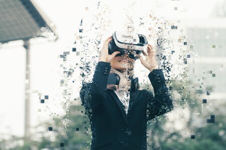 pixelated effect, hijab businesswoman experiencing in virtual reality glasses for controlling successful business solutions and developmentの写真素材