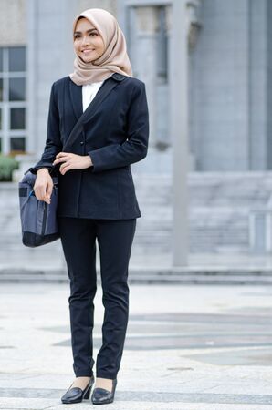 young executive businesswoman in black suit standing with confident face expressionの写真素材