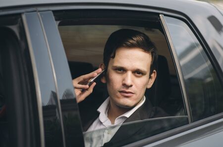 Portrait of young businessman talking to Someone on his Mobile Phone with serious Facial Expression.の写真素材
