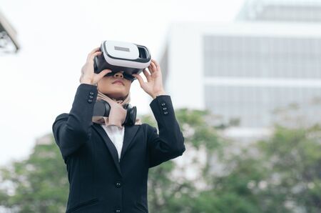 businesswoman experiencing in virtual reality glasses for controlling successful business solutions and developmentの写真素材