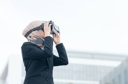 businesswoman experiencing in virtual reality glasses for controlling successful business solutions and developmentの写真素材