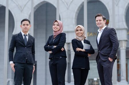 Portrait group of young executive, dressed in formal standing with happy face expressionの写真素材