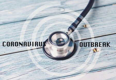 Health care and medical concept, CORONAVIRUS word over stethoscope on wooden backgroundの写真素材