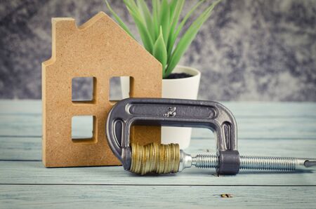 saving money for home concept, piggy bank and home replica on tableの写真素材