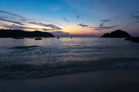 Travel and leisure concept, beautiful sea view scenery over stunning sunrise background.sunlight beam and soft wave hitting sandy beachの写真素材