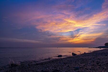Travel and leisure concept, beautiful sea view scenery over stunning sunrise background.sunlight beam and soft wave hitting sandy beachの写真素材
