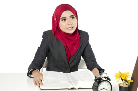 young businesswomen or student in hijab sitting at her workplace in light officeの写真素材