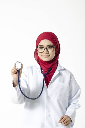 Medical and healthcare concept, confident young doctor standing with smile face holding stethoscopeの写真素材