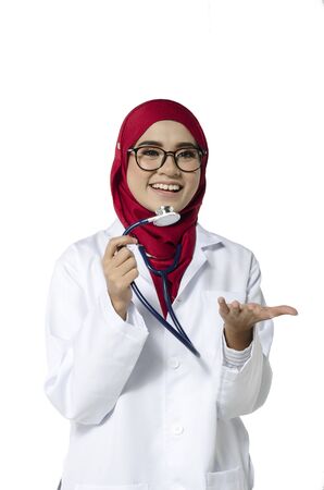 Medical and healthcare concept, confident young doctor standing with smile face holding stethoscopeの写真素材