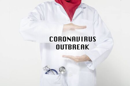 Medical and healthcare concept, young doctor standing with word coronavirus outbreakの写真素材