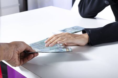 Concept for corruption, young executive sitting and receiving bribe
