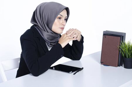 business  concept, young woman with hijab sitting with smile face, look at camera infront against...