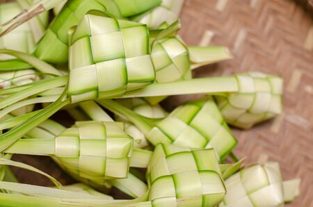 ketupat casing and rice in bamboo container. traditional malay delicacy during Malaysian eid festivalの写真素材