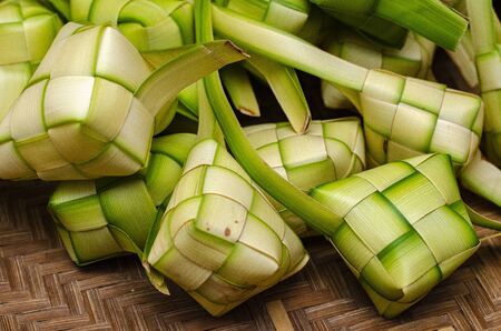 ketupat casing and rice in bamboo container. traditional malay delicacy during Malaysian eid festivalの写真素材