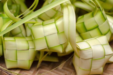 ketupat casing and rice in bamboo container. traditional malay delicacy during Malaysian eid festivalの写真素材