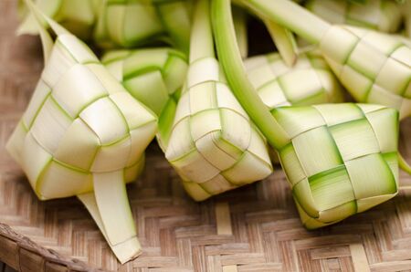 ketupat casing and rice in bamboo container. traditional malay delicacy during Malaysian eid festivalの写真素材
