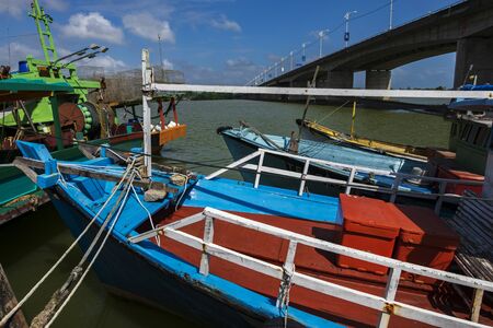Traditional fishing boat moored at village located in Terengganu, Malaysia under blue sky backgroundの写真素材