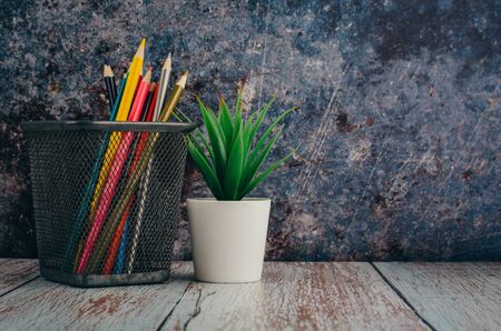 Back to school and offices stationary concept, stack of colored pens markers In a metal case over dark backgroundの写真素材