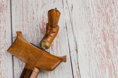 Traditional dagger called Keris on wooden background, Keris  is unique icon among Malay Ethnic cultural history in Malaysiaの写真素材