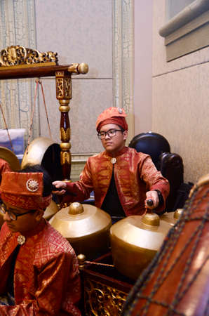 KUALA LUMPUR, MALAYSIA 12 JULY 2017: Group of Malaysian with songket performing Gamelan Orchestra and modern music instrumentのeditorial素材