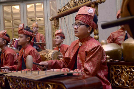 KUALA LUMPUR, MALAYSIA 12 JULY 2017: Group of Malaysian with songket performing Gamelan Orchestra and modern music instrumentのeditorial素材