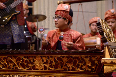KUALA LUMPUR, MALAYSIA 12 JULY 2017: Group of Malaysian with songket performing Gamelan Orchestra and modern music instrumentのeditorial素材