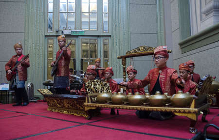 KUALA LUMPUR, MALAYSIA 12 JULY 2017: Group of Malaysian with songket performing Gamelan Orchestra and modern music instrumentのeditorial素材