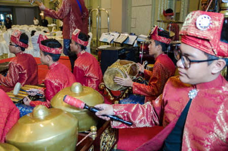 KUALA LUMPUR, MALAYSIA 12 JULY 2017: Group of Malaysian with songket performing Gamelan Orchestra and modern music instrumentのeditorial素材