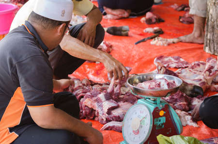 Kuala Terengganu, Malaysia - September 3, 2017: Group of Malaysian Muslims community butchering cow's meat during Eid Al-Adha Mubarak celebration, the Festival of Sacrifice to remember the story of Prophet Abraham and his son, Ismaelのeditorial素材