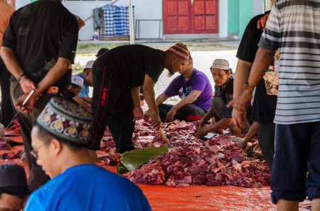 Kuala Terengganu, Malaysia - September 3, 2017: Group of Malaysian Muslims community butchering cow's meat during Eid Al-Adha Mubarak celebration, the Festival of Sacrifice to remember the story of Prophet Abraham and his son, Ismaelのeditorial素材