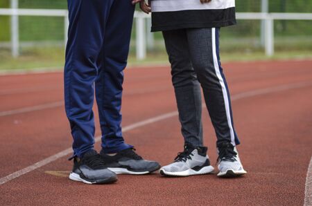 young happy couple enjoying in a healthy lifestyle, warming up and stretching before joggingの写真素材