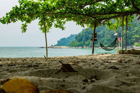 empty hammock for relaxing at the beach during summer vacation at Pangkor Island located in Perak State, Malaysiaの写真素材