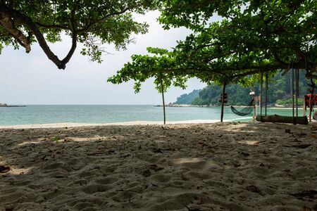 empty hammock for relaxing at the beach during summer vacation at Pangkor Island located in Perak State, Malaysiaの写真素材