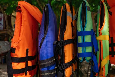 Close-up group of Life jacket or life vest hanging under the shelter at Pangkor Island, Malaysiaの写真素材