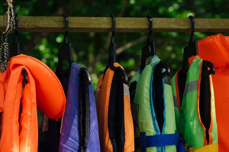 Close-up group of Life jacket or life vest hanging under the shelter at Pangkor Island, Malaysiaの写真素材