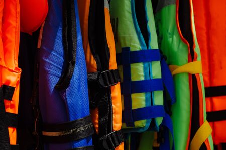 Close-up group of Life jacket or life vest hanging under the shelter at Pangkor Island, Malaysiaの写真素材