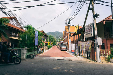PANGKOR ISLAND, MALAYSIA - MARCH 15, 2020: Budget hotel and chelet along the road at Nipah Bayのeditorial素材