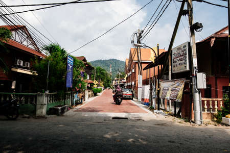 PANGKOR ISLAND, MALAYSIA - MARCH 15, 2020: Budget hotel and chelet along the road at Nipah Bayのeditorial素材