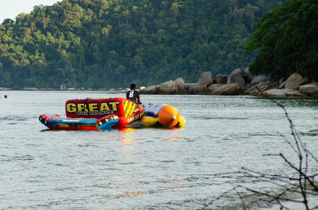 PANGKOR ISLAND, MALAYSIA - MARCH 15, 2020: Boat for island hopping and water sport activities at Nipah Bayのeditorial素材