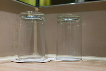Couple of empty drinking glass on wooden tableの写真素材