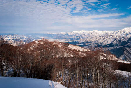 view from top mountain, white snow and beautiful landscape during winter season in Japan against blue sky backgroundの写真素材