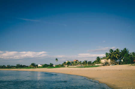 Peaceful view, traditional fihserman village near the seashore againts blue sky and cloudy skyの写真素材