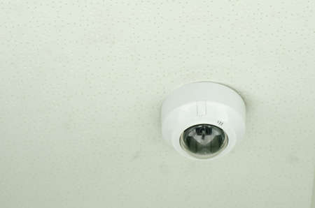 Concept of surveillance and monitoring, modern cctv camera attach to the wallの写真素材