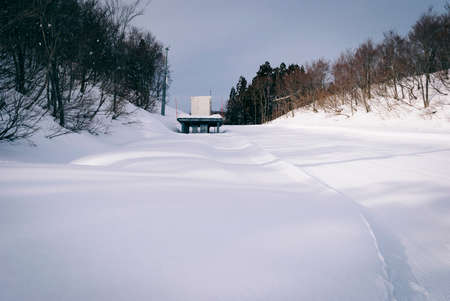 white snow and beautiful landscape during winter season in Japan against blue sky backgroundの写真素材