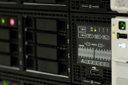 closeup server rack cluster in the datacenter. selective focus shot. noise and grain due to low lightの写真素材