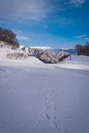 white snow and beautiful landscape during winter season in Japan against blue sky backgroundの写真素材