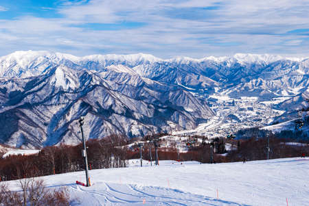 view from top mountain, white snow and beautiful landscape during winter season in Japan against blue sky backgroundの写真素材