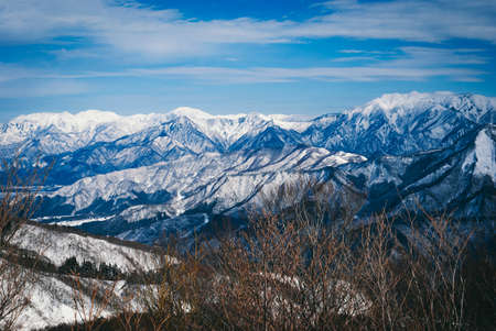view from top mountain, white snow and beautiful landscape during winter season in Japan against blue sky backgroundの写真素材